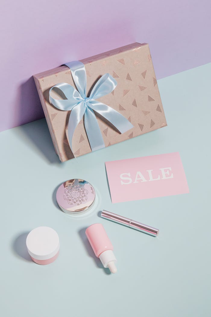 Styled flat lay of beauty products and gift box for sales promotion.
