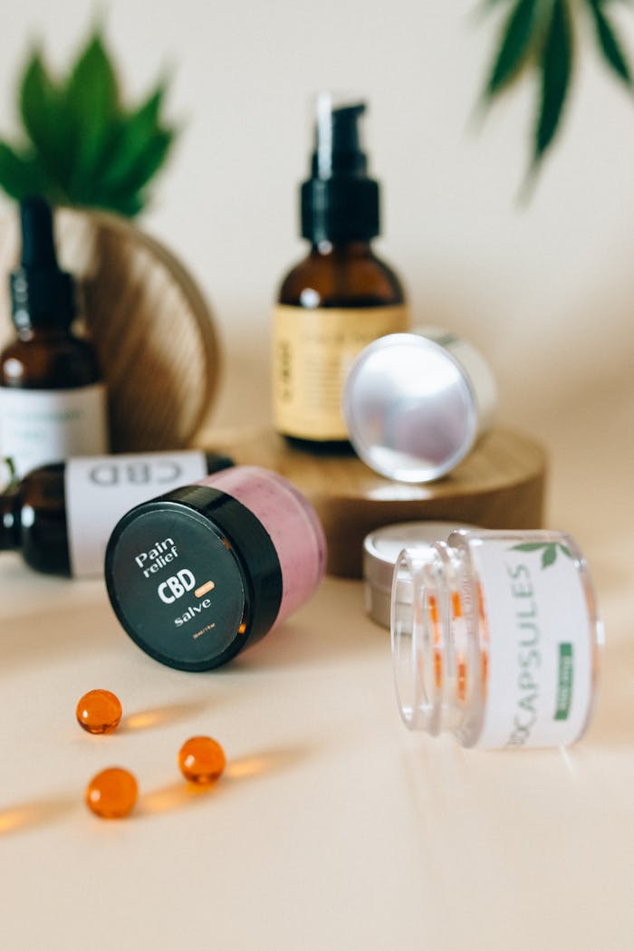 Assorted CBD products including salve, capsules, and oils elegantly arranged on a surface.